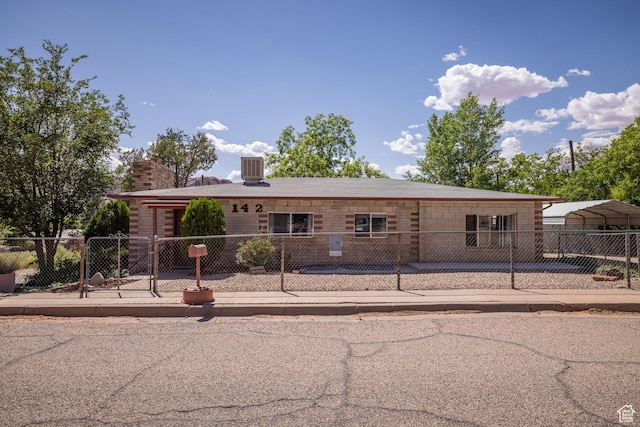 142 Hillside Dr, Moab, UT 84532 - view of front of house featuring a fenced front yard and a chimney