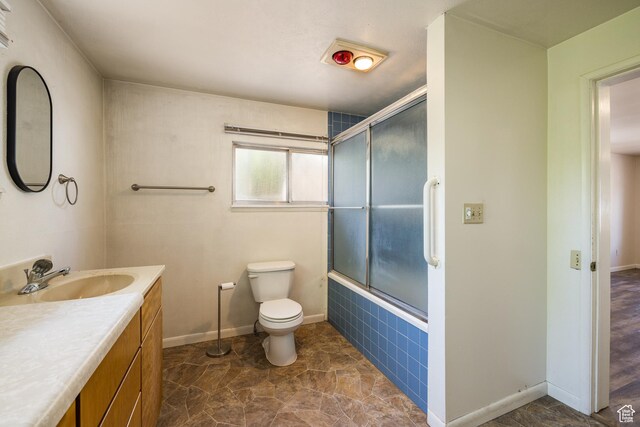 142 Hillside Dr, Moab, UT 84532 - full bathroom featuring toilet, shower / bath combination with glass door, vanity, and baseboards
