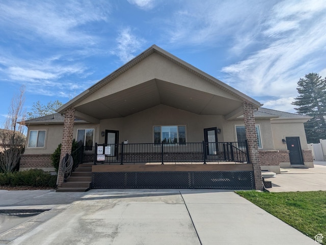 view of front of property with stucco siding and brick siding