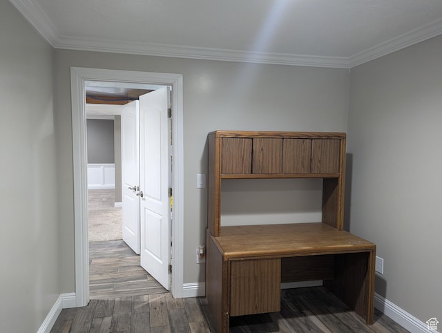 hallway featuring dark wood-type flooring, ornamental molding, and baseboards