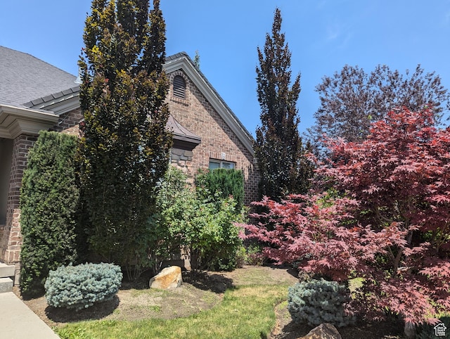 3312 W Country Bluff Rd Unit 5, South Jordan, UT 84095 - view of home's exterior featuring brick siding, stone siding, and roof with shingles
