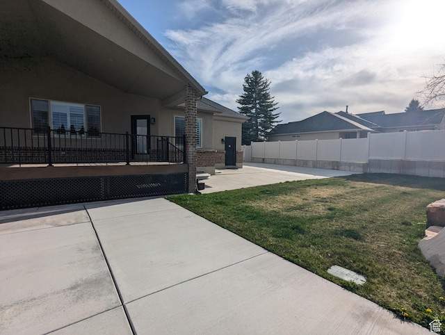 view of yard featuring a patio area and a deck