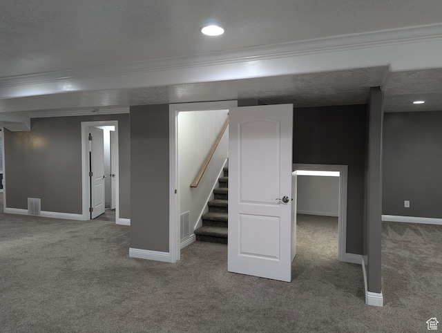 finished below grade area with carpet floors, ornamental molding, baseboards, stairs, and recessed lighting
