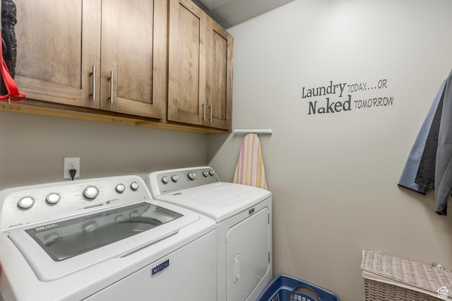 laundry area featuring independent washer and dryer and cabinet space