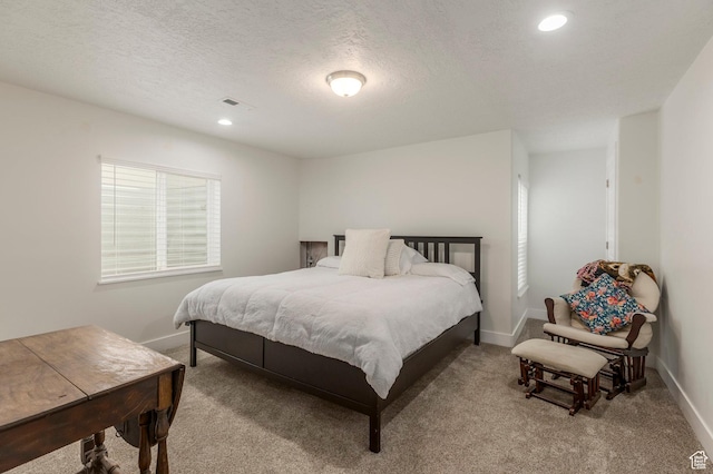 carpeted bedroom with baseboards, recessed lighting, and a textured ceiling