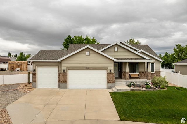 craftsman-style house with brick siding, a garage, driveway, and a shingled roof