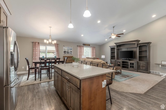 kitchen featuring stainless steel fridge with ice dispenser, healthy amount of natural light, a chandelier, dark wood-style flooring, and lofted ceiling