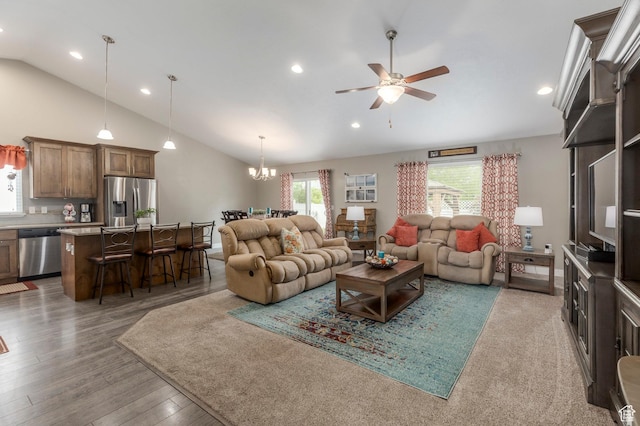 living area with vaulted ceiling, ceiling fan, a chandelier, recessed lighting, and wood finished floors