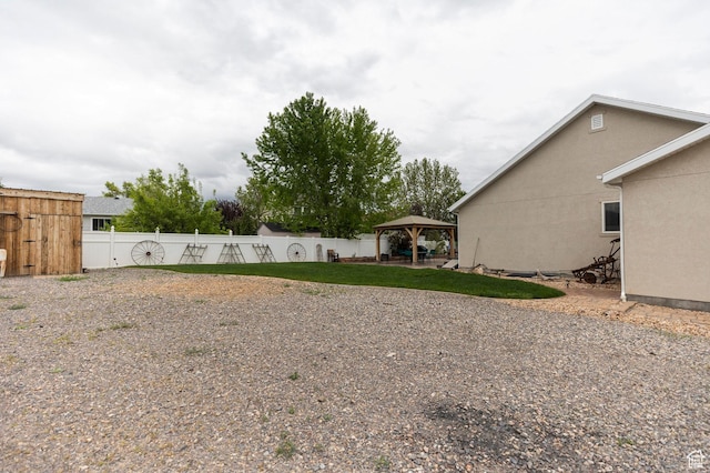 view of yard with a gazebo and fence