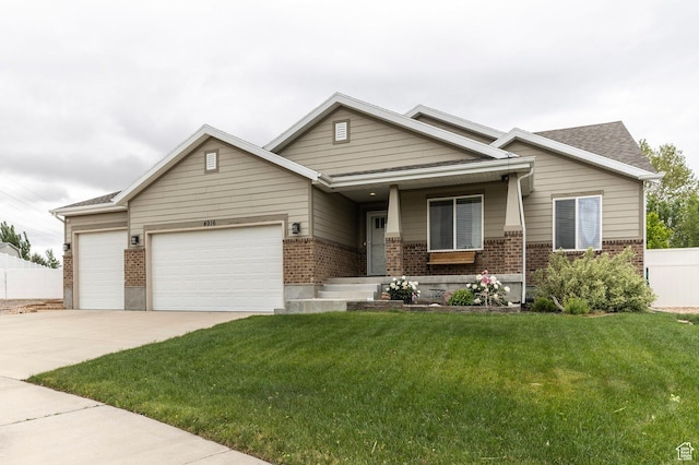 view of front of home with brick siding, an attached garage, a front lawn, a porch, and concrete driveway