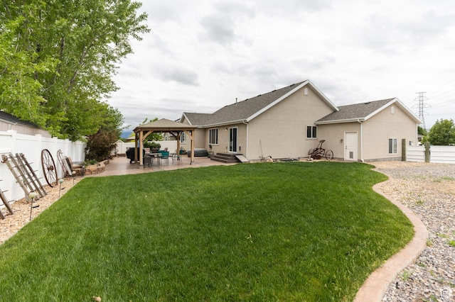 back of house featuring a gazebo, stucco siding, and a patio area