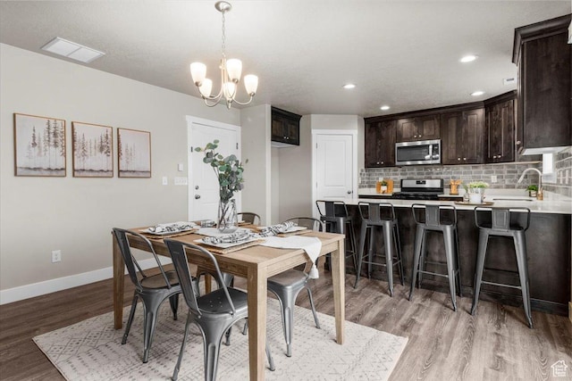 930 N 90 W, Santaquin, UT 84655 - dining area featuring light wood-style floors, baseboards, a chandelier, and recessed lighting