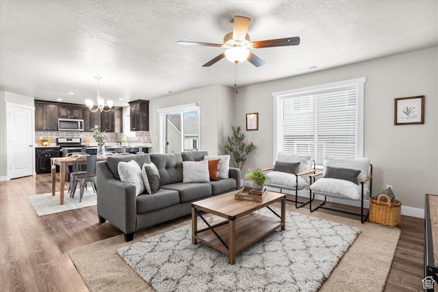 930 N 90 W, Santaquin, UT 84655 - living room with a chandelier, ceiling fan, light wood-style flooring, a textured ceiling, and baseboards