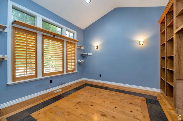 14046 S Emmeline Dr, Herriman, UT 84096 - spare room with wood-type flooring, lofted ceiling, and baseboards
