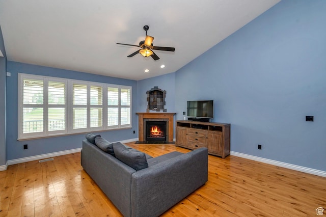 14046 S Emmeline Dr, Herriman, UT 84096 - living area with ceiling fan, baseboards, light wood-type flooring, lofted ceiling, and a lit fireplace