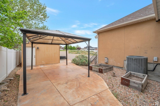 14046 S Emmeline Dr, Herriman, UT 84096 - view of patio with cooling unit, a gazebo, a garden, and a fenced backyard