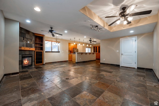 14046 S Emmeline Dr, Herriman, UT 84096 - unfurnished living room featuring baseboards, ceiling fan, recessed lighting, and stone tile floors