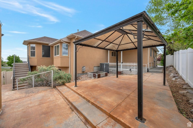 14046 S Emmeline Dr, Herriman, UT 84096 - view of patio featuring a fenced backyard, a gazebo, stairway, and cooling unit