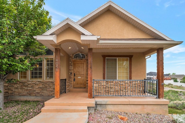 14046 S Emmeline Dr, Herriman, UT 84096 - doorway to property featuring stucco siding, covered porch, and stone siding