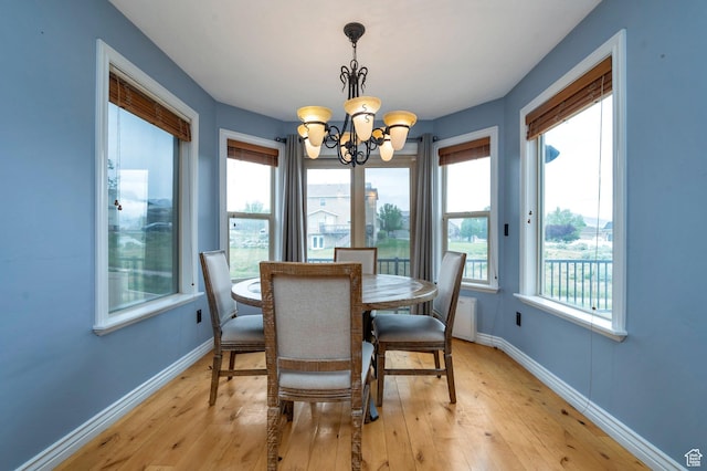 14046 S Emmeline Dr, Herriman, UT 84096 - dining room featuring a chandelier, light wood finished floors, and baseboards