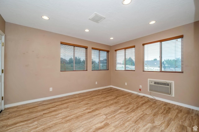 14046 S Emmeline Dr, Herriman, UT 84096 - spare room with a wall mounted AC, recessed lighting, baseboards, and light wood-style floors