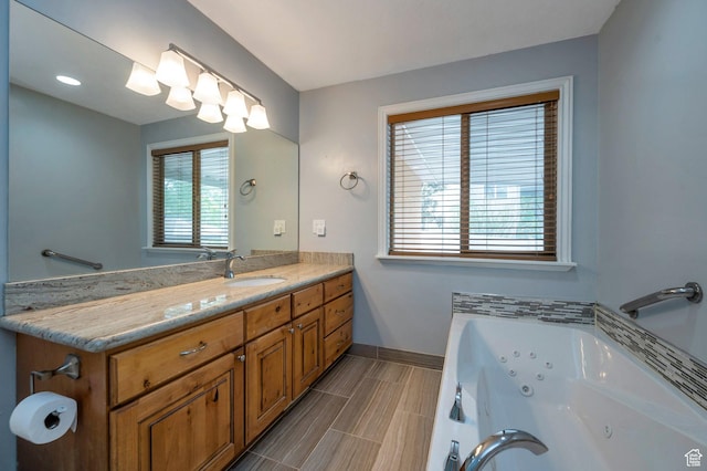 14046 S Emmeline Dr, Herriman, UT 84096 - bathroom featuring baseboards, a whirlpool tub, and vanity