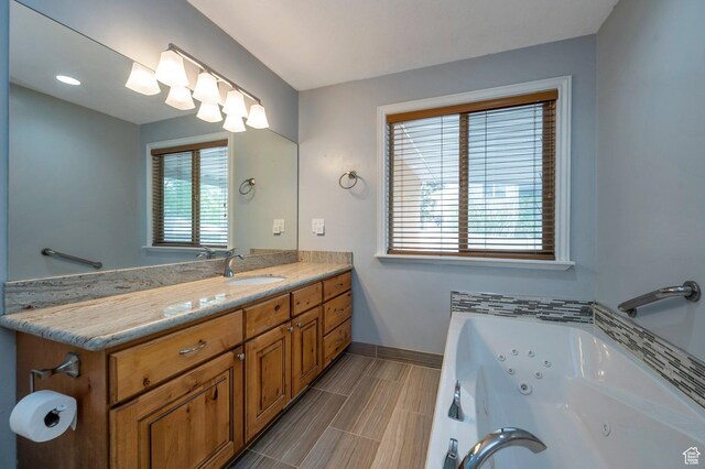 14046 S Emmeline Dr, Herriman, UT 84096 - bathroom featuring baseboards, a whirlpool tub, and vanity