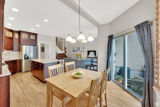 dining room with a chandelier, stairs, light wood finished floors, and recessed lighting
