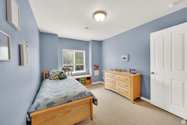 bedroom featuring light colored carpet and baseboards