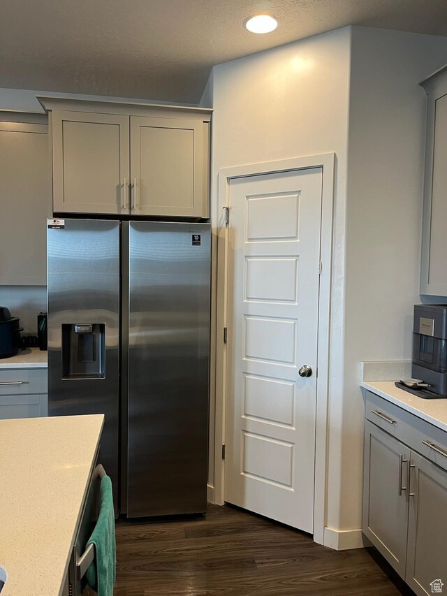 7747 N Seabiscuit Rd, Eagle Mountain, UT 84005 - kitchen with stainless steel fridge with ice dispenser, gray cabinets, dark wood finished floors, light countertops, and recessed lighting