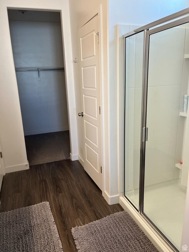 7747 N Seabiscuit Rd, Eagle Mountain, UT 84005 - full bath featuring wood finished floors, a stall shower, and baseboards