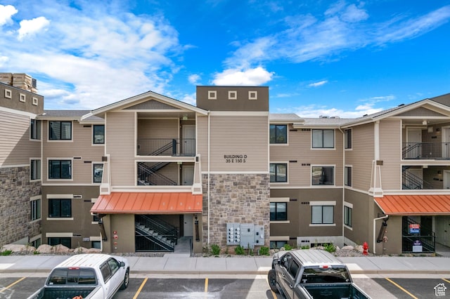 35 E 150th St S Unit D101, Garden City, UT 84028 - view of apartment building / complex featuring uncovered parking and stairs