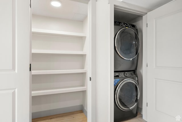 35 E 150th St S Unit D101, Garden City, UT 84028 - clothes washing area with estacked washer and dryer and wood finished floors