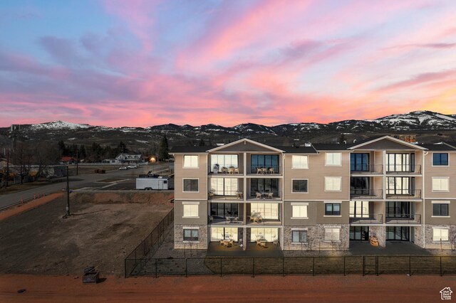 35 E 150th St S Unit D101, Garden City, UT 84028 - property at dusk with a mountain view and a fenced backyard