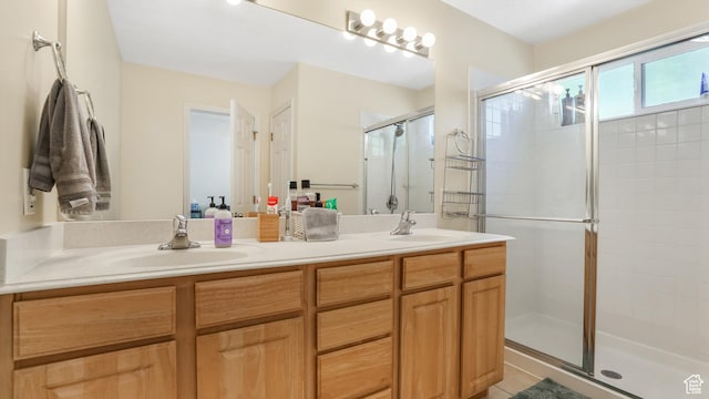 bathroom featuring a shower stall, double vanity, and tile patterned floors