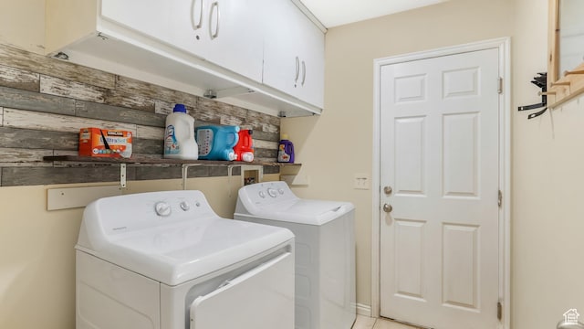 washroom with washer and dryer and cabinet space