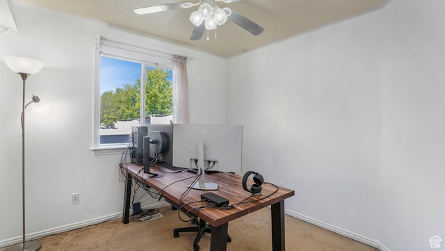 office space with carpet floors, a ceiling fan, and baseboards