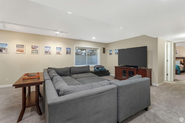 living room featuring light colored carpet, baseboards, track lighting, and recessed lighting