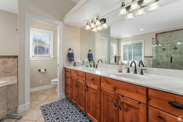 full bath featuring a stall shower, tile patterned flooring, double vanity, toilet, and baseboards