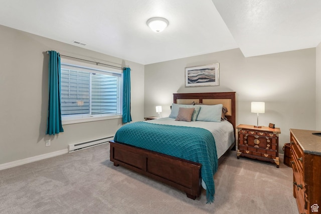 carpeted bedroom featuring baseboard heating and baseboards