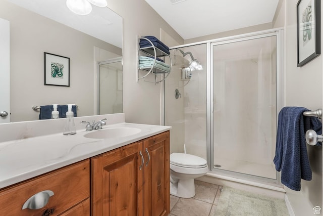 bathroom with a shower stall, tile patterned floors, toilet, and vanity