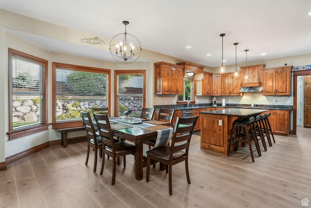 dining room with a chandelier, light wood finished floors, baseboards, and recessed lighting
