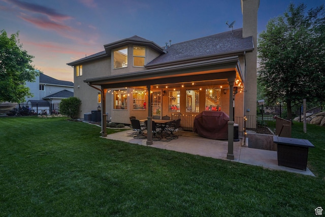 rear view of house featuring a patio, central AC unit, stucco siding, and a chimney