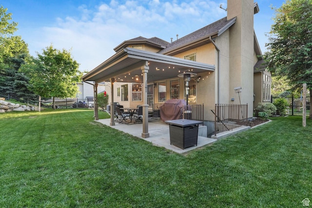 back of house featuring a patio area, stucco siding, and a chimney