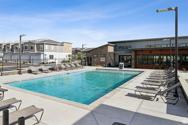 3714 W Soft Whisper Way, Herriman, UT 84096 - community pool with a residential view, fence, and a patio area