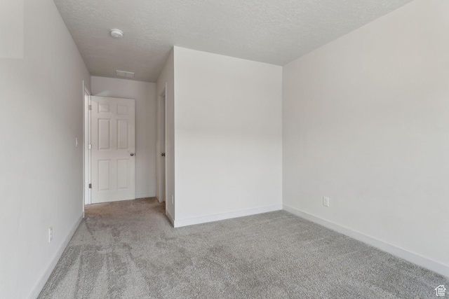 3714 W Soft Whisper Way, Herriman, UT 84096 - empty room featuring carpet flooring, baseboards, a textured ceiling, and a smoke detector