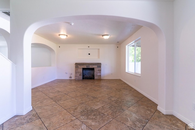 886 Cambridge Dr, North Salt Lake, UT 84054 - unfurnished living room with a stone fireplace and baseboards