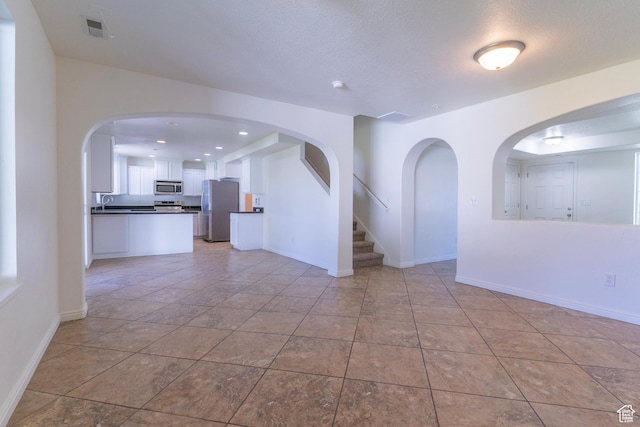 886 Cambridge Dr, North Salt Lake, UT 84054 - spare room with baseboards, recessed lighting, a sink, and light tile patterned floors