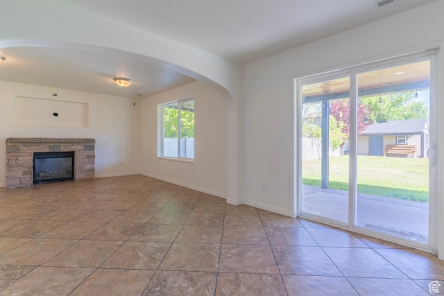 886 Cambridge Dr, North Salt Lake, UT 84054 - unfurnished living room with tile patterned floors, baseboards, and arched walkways