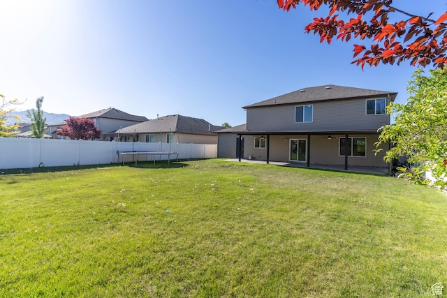 886 Cambridge Dr, North Salt Lake, UT 84054 - rear view of property featuring a trampoline and a patio